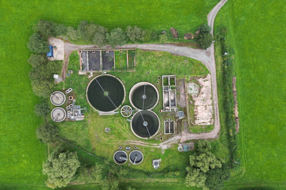Aerial view of a wastewater treatment plant with circular clarifiers